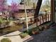 Charming backyard with patio, bridge over creek, and views of mature landscaping and exterior of stone house at 1633 18Th St # 2, Boulder, CO 80302