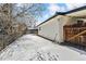 Snowy backyard with wooden fence and side access at 770 S Arbutus St, Lakewood, CO 80228