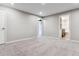 Finished basement area with neutral carpeting and doors to bathroom at 770 S Arbutus St, Lakewood, CO 80228