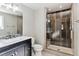 Modern bathroom with a walk-in shower and dark vanity at 770 S Arbutus St, Lakewood, CO 80228