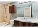 Updated bathroom with a shower/tub combo and dark brown vanity at 770 S Arbutus St, Lakewood, CO 80228