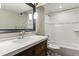 Basement bathroom with tub, shower, and updated vanity at 770 S Arbutus St, Lakewood, CO 80228