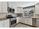 Kitchen with stainless steel appliances and granite counters at 770 S Arbutus St, Lakewood, CO 80228