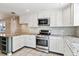 Updated kitchen, featuring stainless steel appliances and white cabinets at 770 S Arbutus St, Lakewood, CO 80228