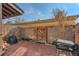 Brick back patio area with wooden fence and outdoor grill, providing an ideal setting for grilling and relaxation at 3706 S Fairplay Way, Aurora, CO 80014