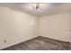 Finished basement area featuring carpeted floors and neutral walls, illuminated by a modern ceiling light fixture at 3706 S Fairplay Way, Aurora, CO 80014