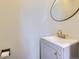 Bathroom featuring a modern vanity with gold fixtures and a round mirror above it at 3706 S Fairplay Way, Aurora, CO 80014