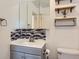 Bathroom featuring updated vanity with decorative mirror and modern fixtures at 3706 S Fairplay Way, Aurora, CO 80014
