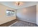 Neutral bedroom with a window showcasing outdoor scenery and soft carpeting at 3706 S Fairplay Way, Aurora, CO 80014