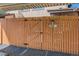 Wooden fence gate with house number, offering privacy and security while maintaining neighborhood charm at 3706 S Fairplay Way, Aurora, CO 80014