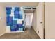 Finished basement hallway showcasing custom blue accent wall and carpet flooring leading to the stairway at 3706 S Fairplay Way, Aurora, CO 80014
