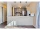 Bright kitchen with stainless steel appliances, gray cabinetry, pendant lights, and a breakfast bar at 3706 S Fairplay Way, Aurora, CO 80014