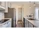 Well-lit kitchen featuring modern appliances and ample cabinet space at 3706 S Fairplay Way, Aurora, CO 80014