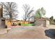 Expansive backyard with a patio, a grill, and a detached garage, perfect for outdoor entertaining at 6411 E 64Th Ave, Commerce City, CO 80022