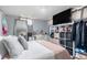 Bright bedroom featuring neutral colors, modern decor, a large mirror, and ample storage space at 6411 E 64Th Ave, Commerce City, CO 80022