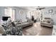 Inviting living room with neutral walls, modern ceiling fan, and stylish decor creating a comfortable atmosphere at 6411 E 64Th Ave, Commerce City, CO 80022