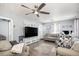 Spacious living room featuring hardwood floors, modern ceiling fan and plenty of room for entertaining at 6411 E 64Th Ave, Commerce City, CO 80022