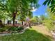 Sprawling backyard view, showing the home's large deck, stairs and mature trees at 9466 Morning Glory Ln, Highlands Ranch, CO 80130