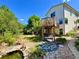 Inviting backyard featuring a charming covered patio with swing, water feature and lush lawn at 9466 Morning Glory Ln, Highlands Ranch, CO 80130