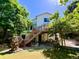 View of home's exterior from backyard showcasing elevated deck with stairs and landscaping at 9466 Morning Glory Ln, Highlands Ranch, CO 80130