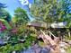 Charming backyard garden pond with a wooden bridge and lush plantings at 9466 Morning Glory Ln, Highlands Ranch, CO 80130
