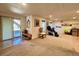 Carpeted basement area with sliding door to the deck and windows providing natural light at 9466 Morning Glory Ln, Highlands Ranch, CO 80130
