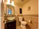 Half bath featuring a vessel sink, stylish tile, and modern fixtures at 9466 Morning Glory Ln, Highlands Ranch, CO 80130