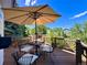 Outdoor deck area with patio furniture and lush green trees in the background with blue skies at 9466 Morning Glory Ln, Highlands Ranch, CO 80130
