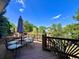 Charming deck area with comfortable seating surrounded by lush trees, perfect for relaxation at 9466 Morning Glory Ln, Highlands Ranch, CO 80130