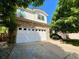 Two-story home featuring a stone facade, attached two-car garage, and a well-maintained driveway at 9466 Morning Glory Ln, Highlands Ranch, CO 80130