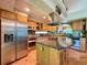 Modern kitchen with stainless steel appliances, wooden cabinets, and a functional center island at 9466 Morning Glory Ln, Highlands Ranch, CO 80130
