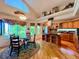 Open kitchen and dining area featuring hardwood floors, an island, and modern appliances at 9466 Morning Glory Ln, Highlands Ranch, CO 80130