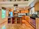Spacious kitchen featuring wood cabinetry, a center island with countertops, and hardwood floors at 9466 Morning Glory Ln, Highlands Ranch, CO 80130