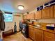 Functional laundry room with washer, dryer, sink, and storage cabinets at 9466 Morning Glory Ln, Highlands Ranch, CO 80130