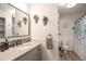 Modern bathroom featuring a granite countertop vanity and shower with tub at 10991 E Vassar Dr, Aurora, CO 80014