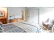 Cozy bedroom with a comfortable bed, dresser, and an accent chair at 10991 E Vassar Dr, Aurora, CO 80014