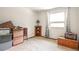 Cozy bedroom with large window, storage boxes and chest at 10991 E Vassar Dr, Aurora, CO 80014