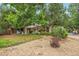 Single-story home with attractive front yard landscaping, a covered porch, and mature trees at 10991 E Vassar Dr, Aurora, CO 80014