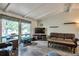 Bright living room with large windows, hardwood floors, and comfortable seating at 10991 E Vassar Dr, Aurora, CO 80014