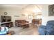 Inviting living room with vaulted ceilings and seamlessly connected dining area at 10991 E Vassar Dr, Aurora, CO 80014