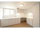 Well-lit office with built-in desk, drawers, cabinets, and a window for natural light at 10991 E Vassar Dr, Aurora, CO 80014
