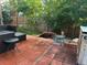 Backyard patio with brick flooring, outdoor furniture, and a tranquil water feature at 10991 E Vassar Dr, Aurora, CO 80014