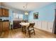 Bright dining area with hardwood floors, a modern light fixture, and a window for natural light at 3630 S Hillcrest Dr, Denver, CO 80237