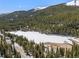 Wonderful aerial view of a lake nestled in a mountainous region with snow-capped peaks at 563 Brook Dr, Idaho Springs, CO 80452