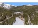 Stunning aerial perspective of a serene lake with forested areas and mountain views at 563 Brook Dr, Idaho Springs, CO 80452