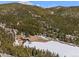 Expansive aerial view showcasing the lake and lush green landscape with scattered homes at 563 Brook Dr, Idaho Springs, CO 80452