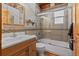 Bathroom featuring a shower-tub combination with glass doors and tiled walls at 563 Brook Dr, Idaho Springs, CO 80452