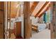 Cozy bedroom with sloped wood ceiling and adjoining bath at 563 Brook Dr, Idaho Springs, CO 80452