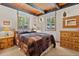 Cozy bedroom featuring wood furnishings and scenic outdoor views from the windows at 563 Brook Dr, Idaho Springs, CO 80452