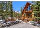 Inviting cabin-style home with a cozy deck, surrounded by lush trees and a mountain view at 563 Brook Dr, Idaho Springs, CO 80452